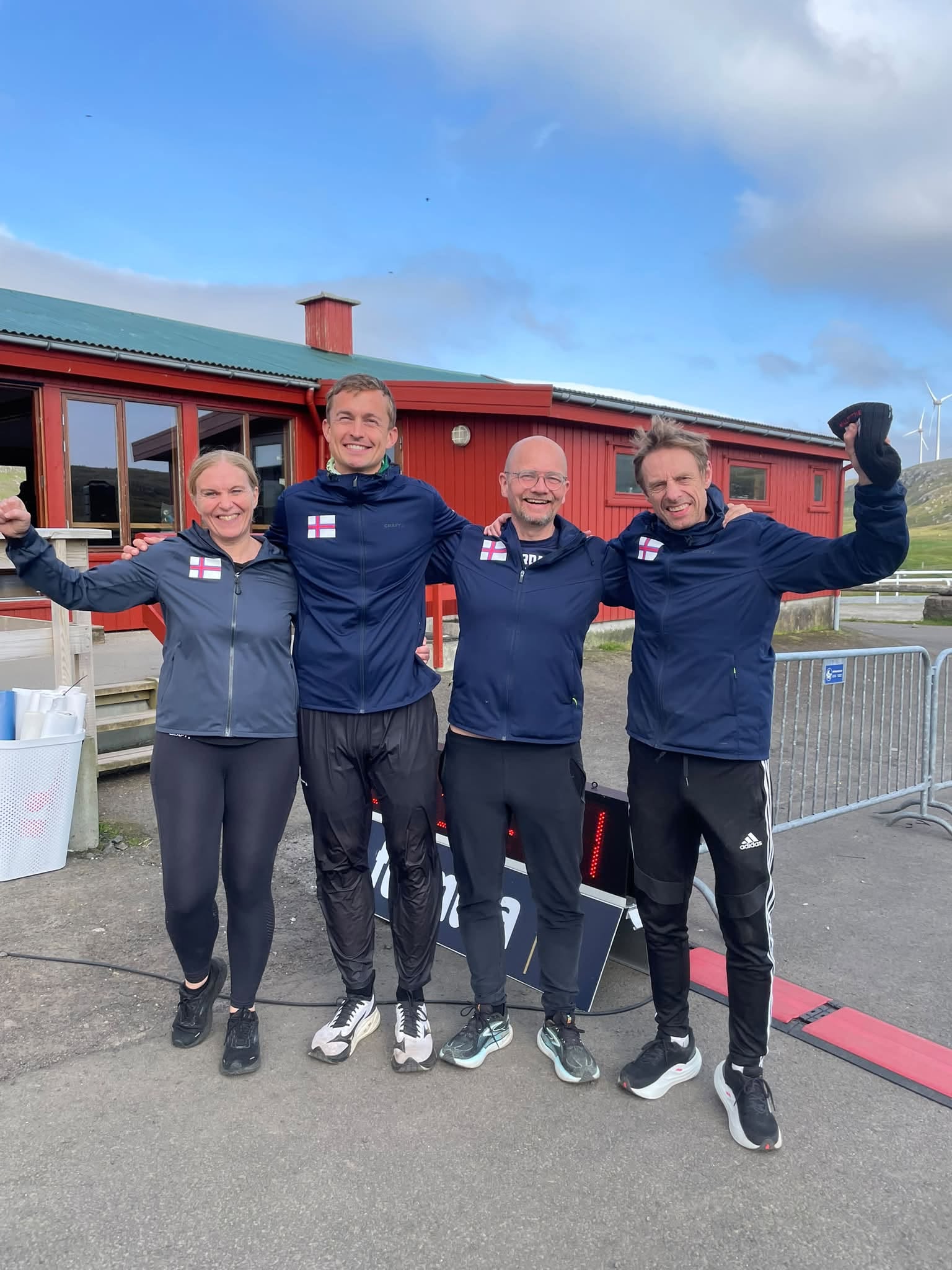 Havnardalur Backyard Ultra organisers Elisabeth Larsen, Peter Jensen, Ólavur Ellefsen and Hallur Holm outside the event venue in 2026.